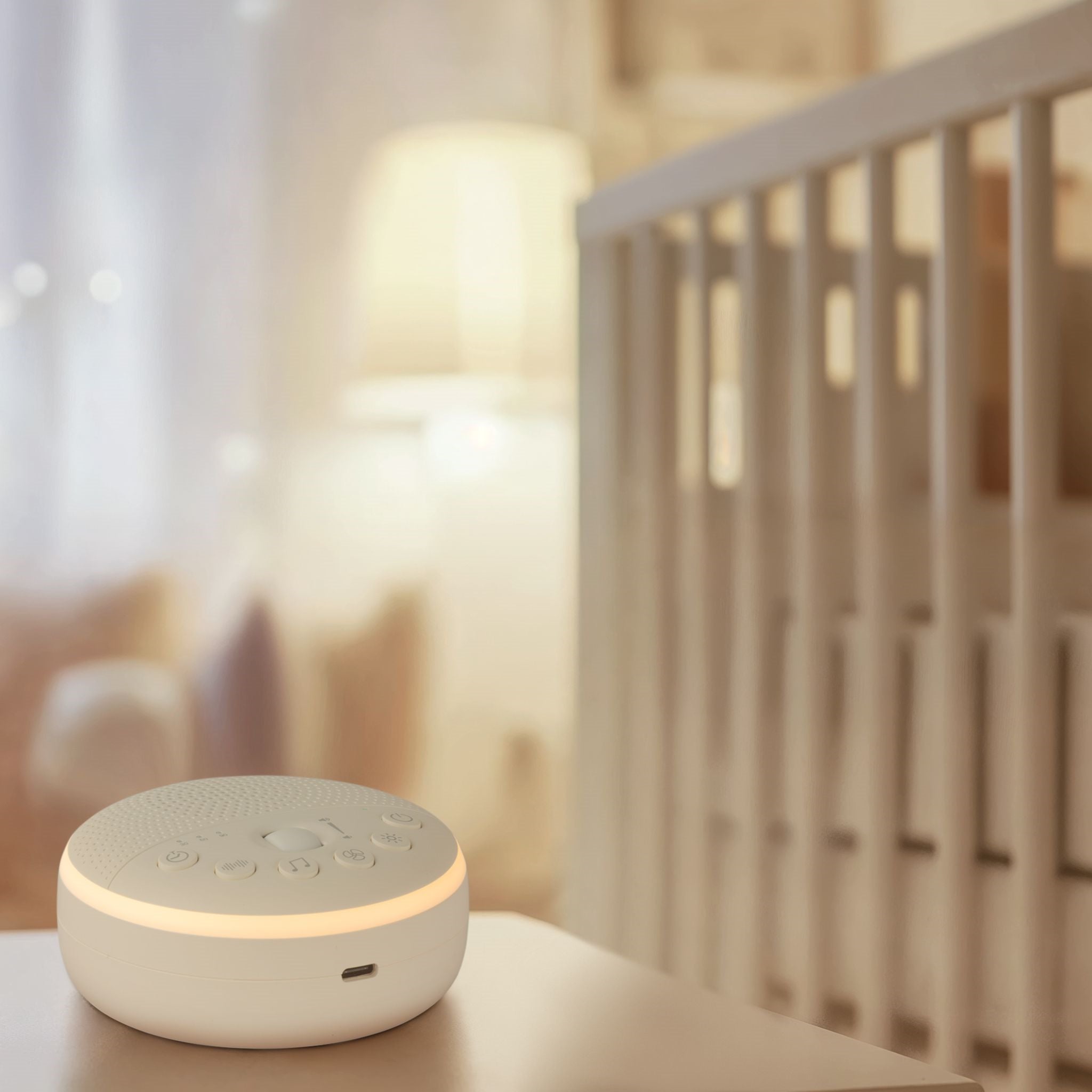 Portable white noise machine and night light in soft white finish for babies