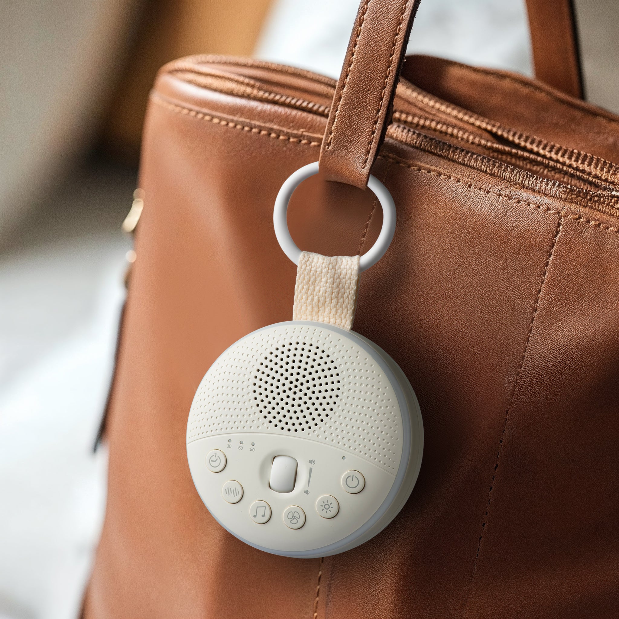 Portable white noise machine with soft night light glow for infant sleep.