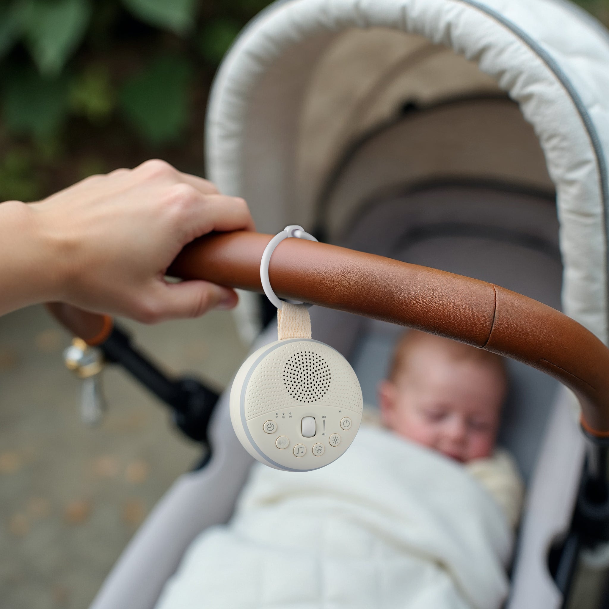Portable white noise machine with soft night light glow for baby sleep.