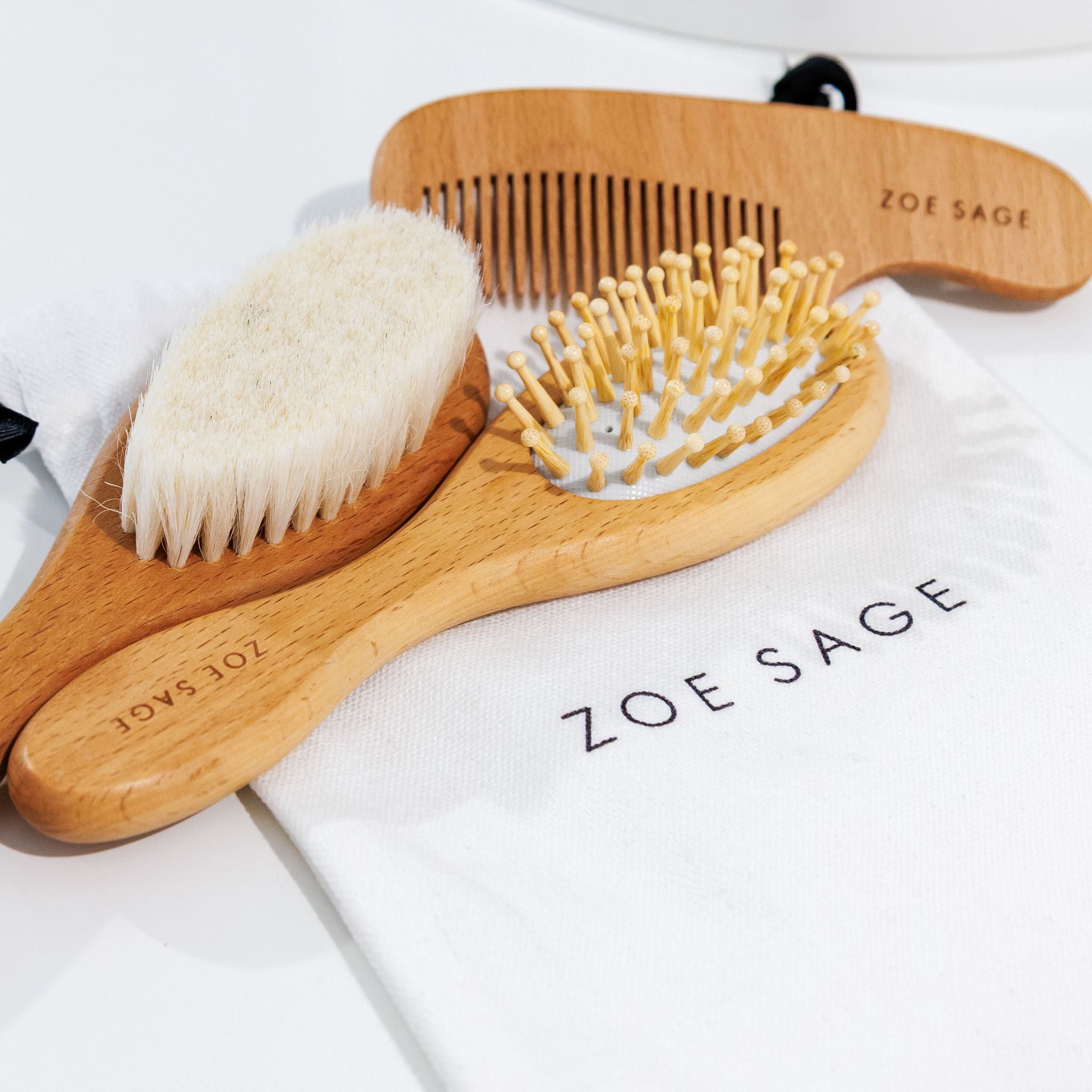 Three piece natural wood baby brush and comb set in neutral tones