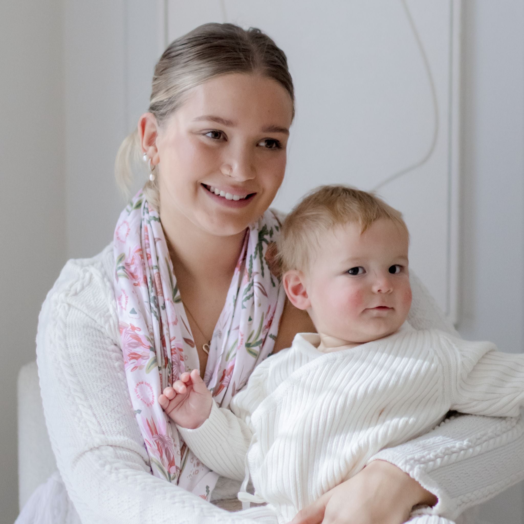 Gumnut Blossoms nursing cover draped over shoulder while feeding baby