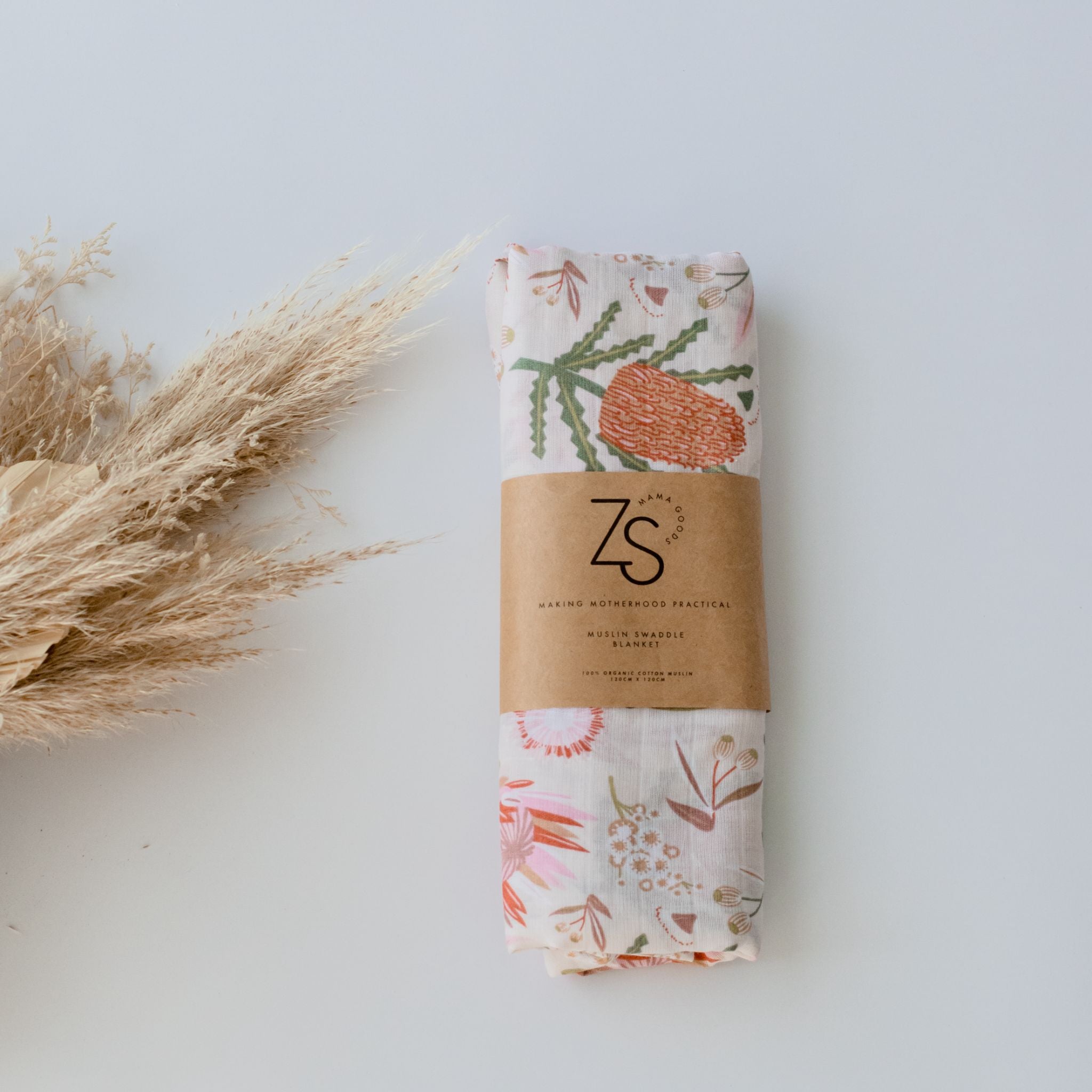 Organic cotton muslin swaddle wrap in gumnut blossom print by Zoe Sage