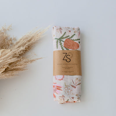 Organic cotton muslin swaddle wrap in gumnut blossom print by Zoe Sage