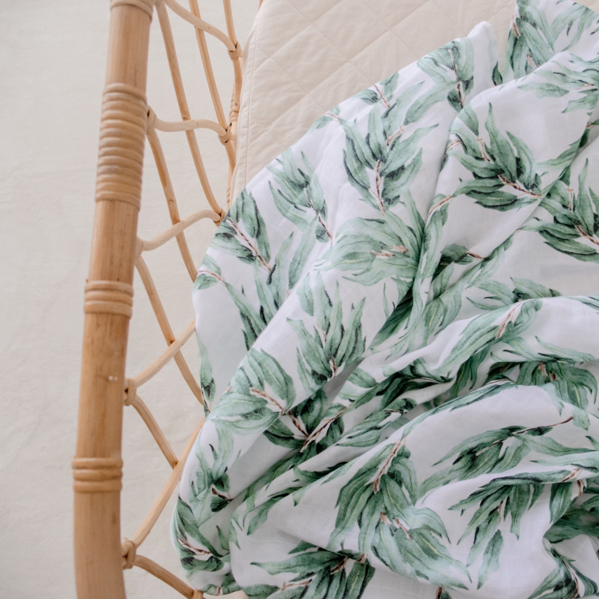 Organic cotton muslin swaddle wrap in soft blue gum leaf color for babies
