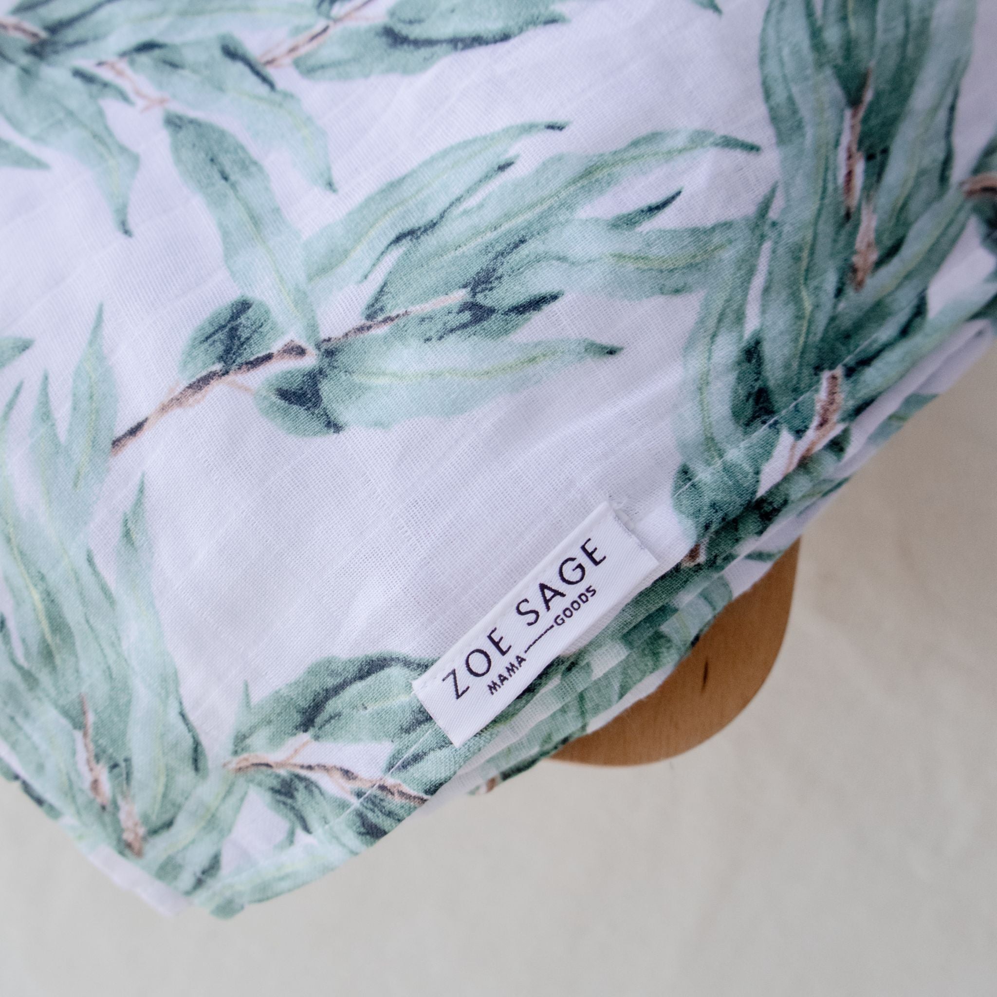 Organic cotton muslin swaddle wrap in blue gum leaf colour folded flat