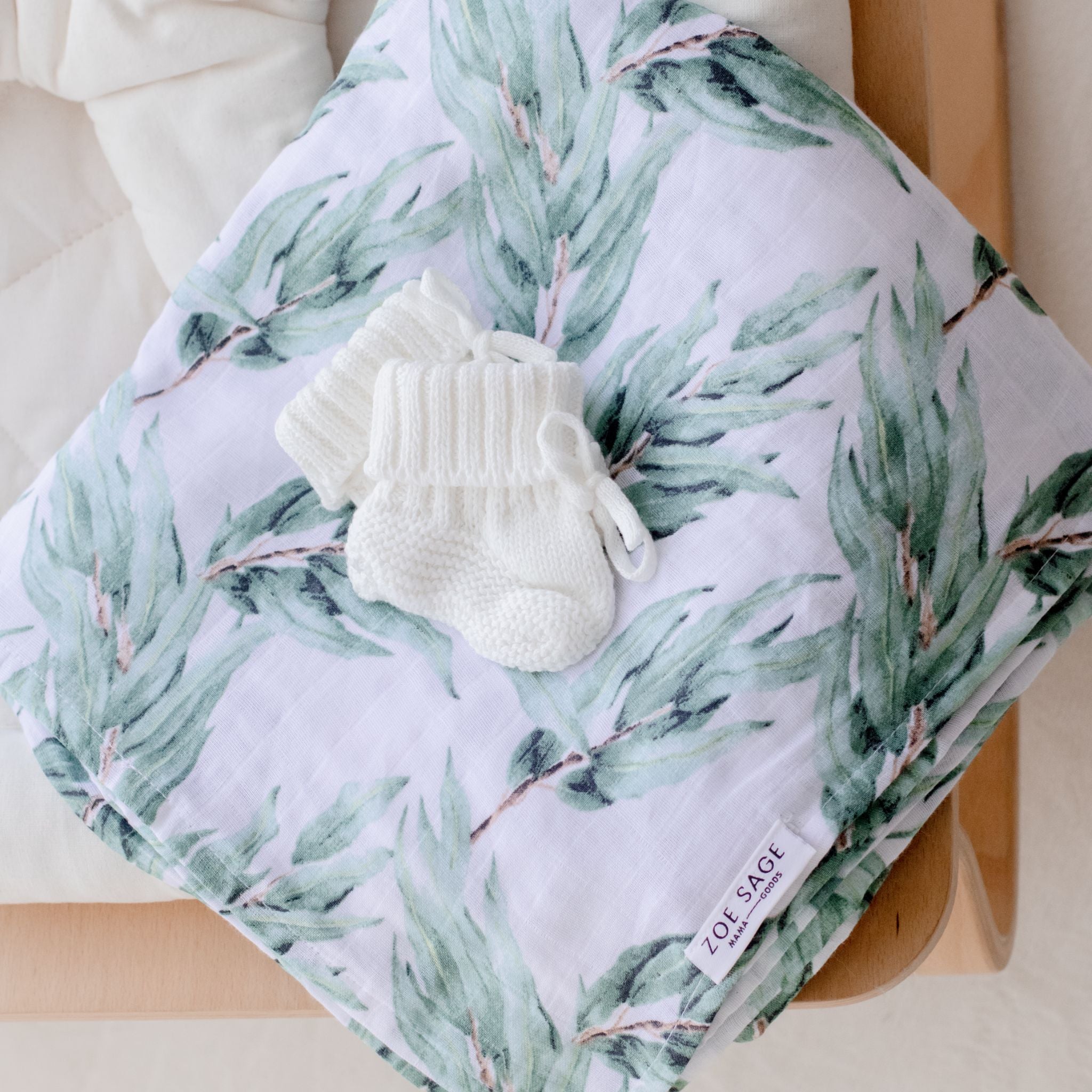 Organic cotton muslin swaddle wrap in soft blue gum leaf color detail