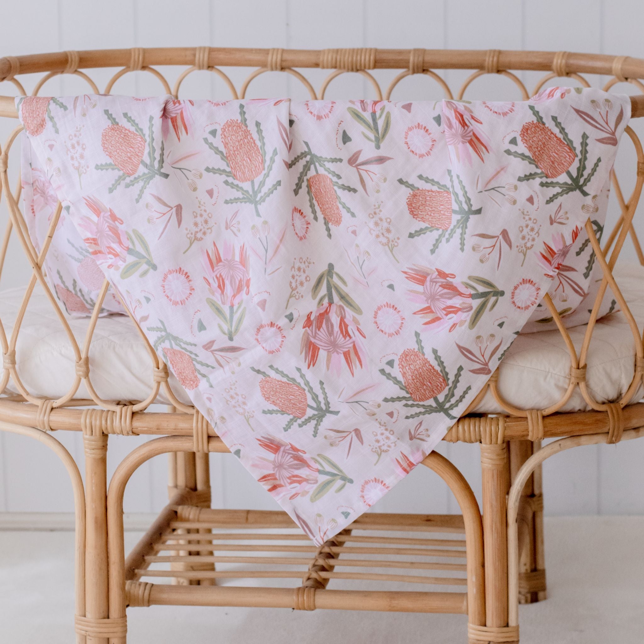 Organic cotton muslin swaddle wrap featuring delicate gumnut blossom print in soft tones