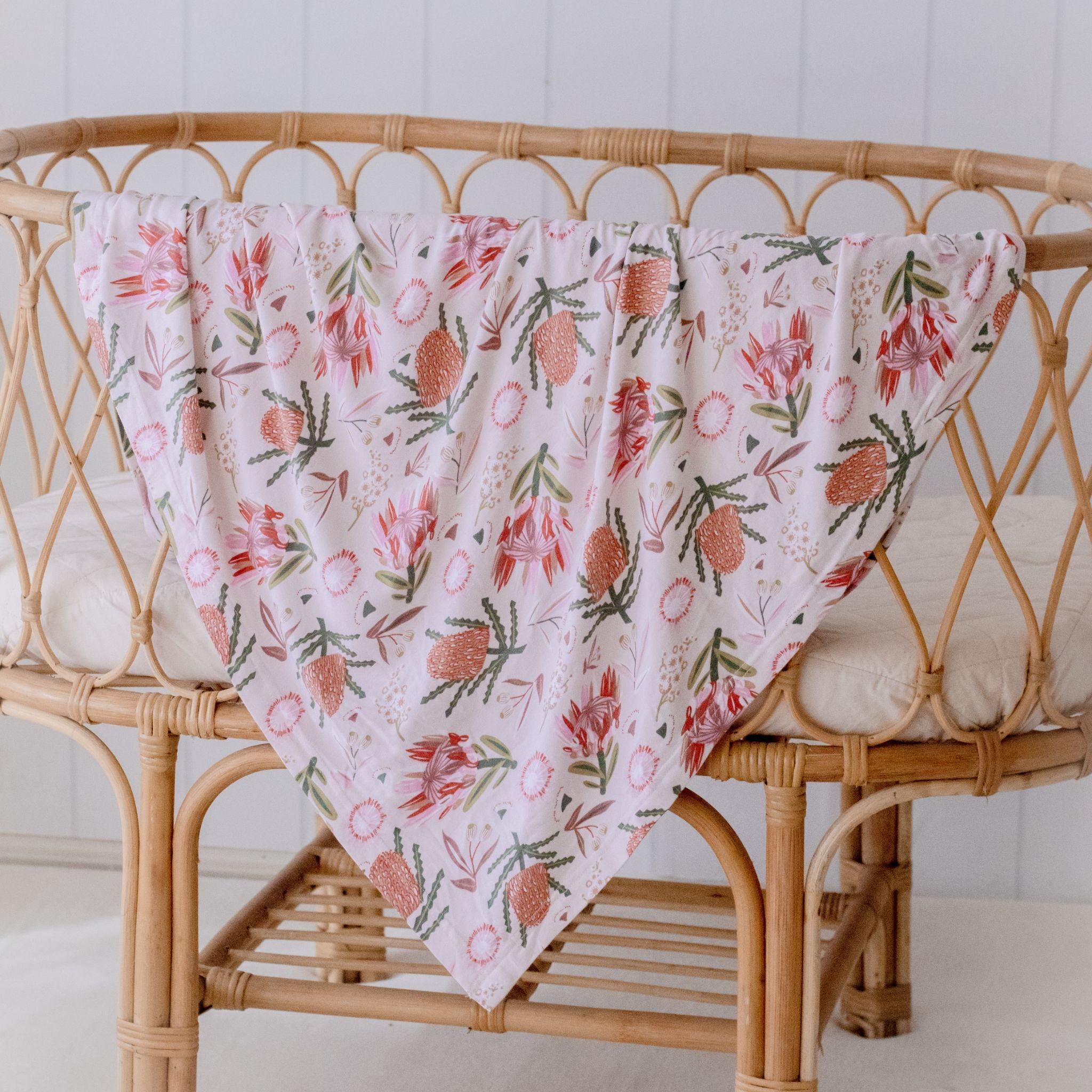 Stretchy baby swaddle wrap in gumnut blossoms design displayed flat
