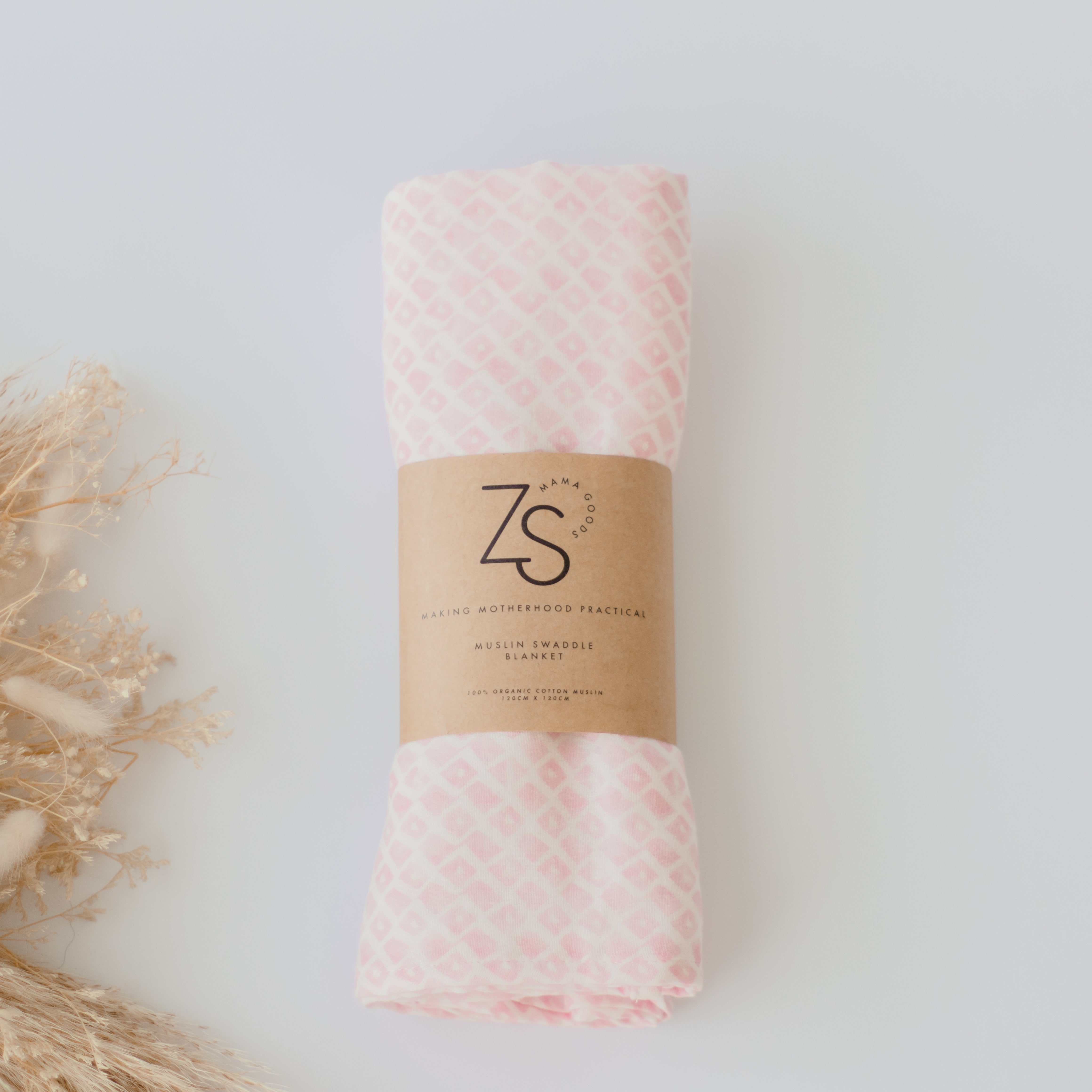 Organic cotton muslin swaddle wrap in rose geometry pattern by Zoe Sage