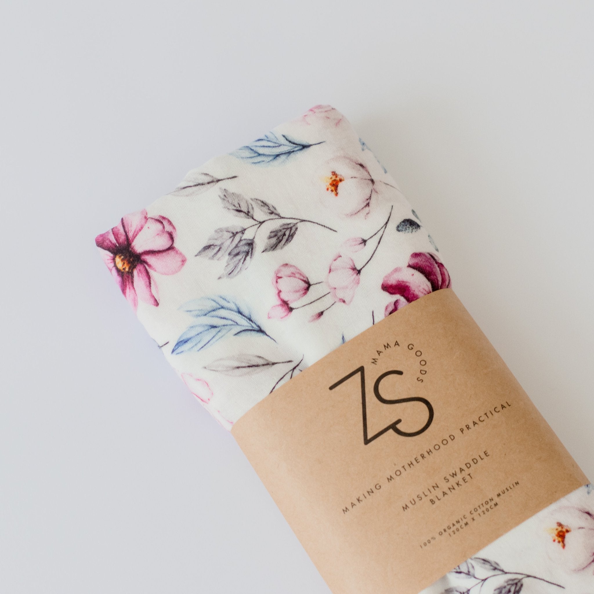 Soft organic cotton muslin swaddle wrap in delicate pink floral print for babies.