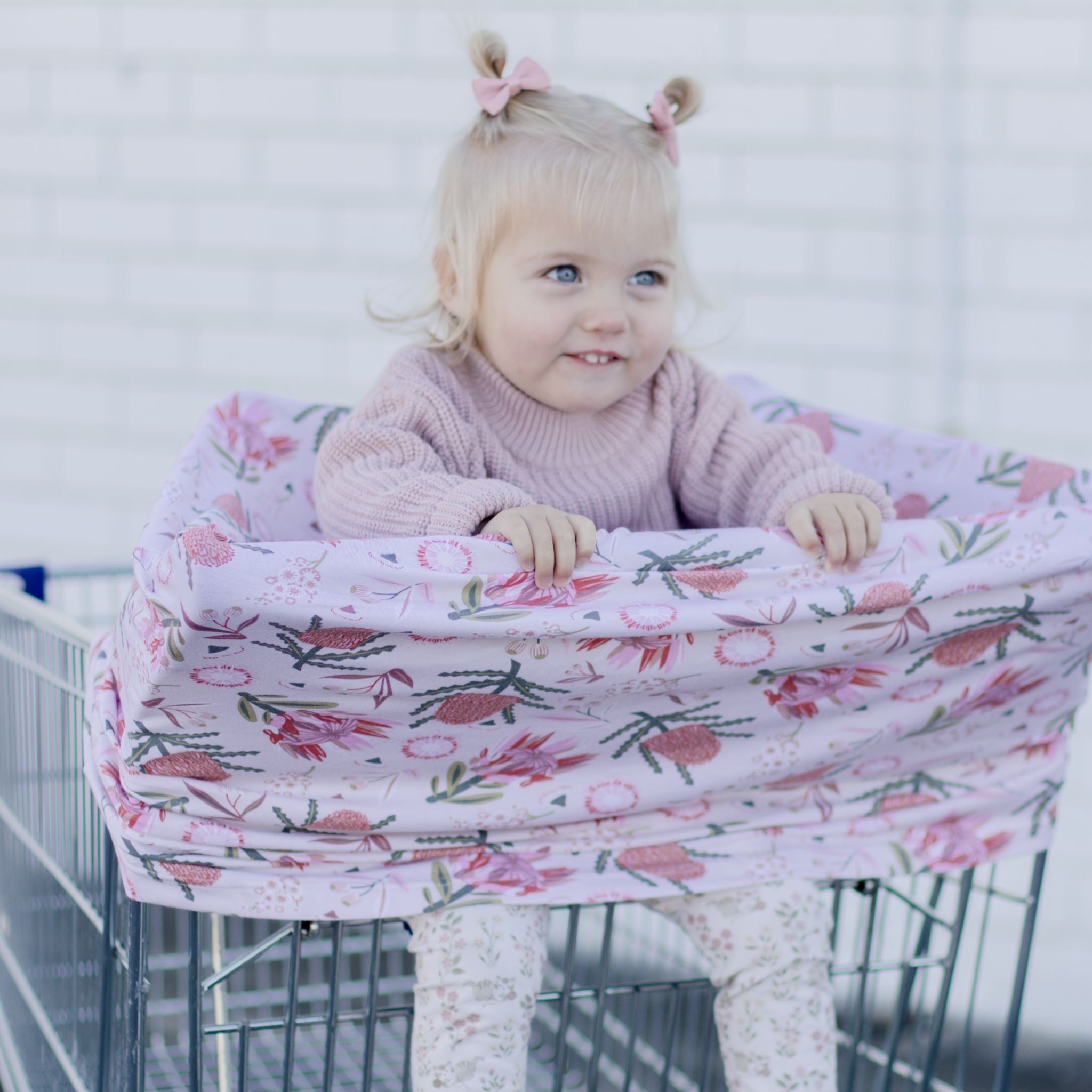 Gumnut blossoms nursing cover draped over shoulder while feeding baby