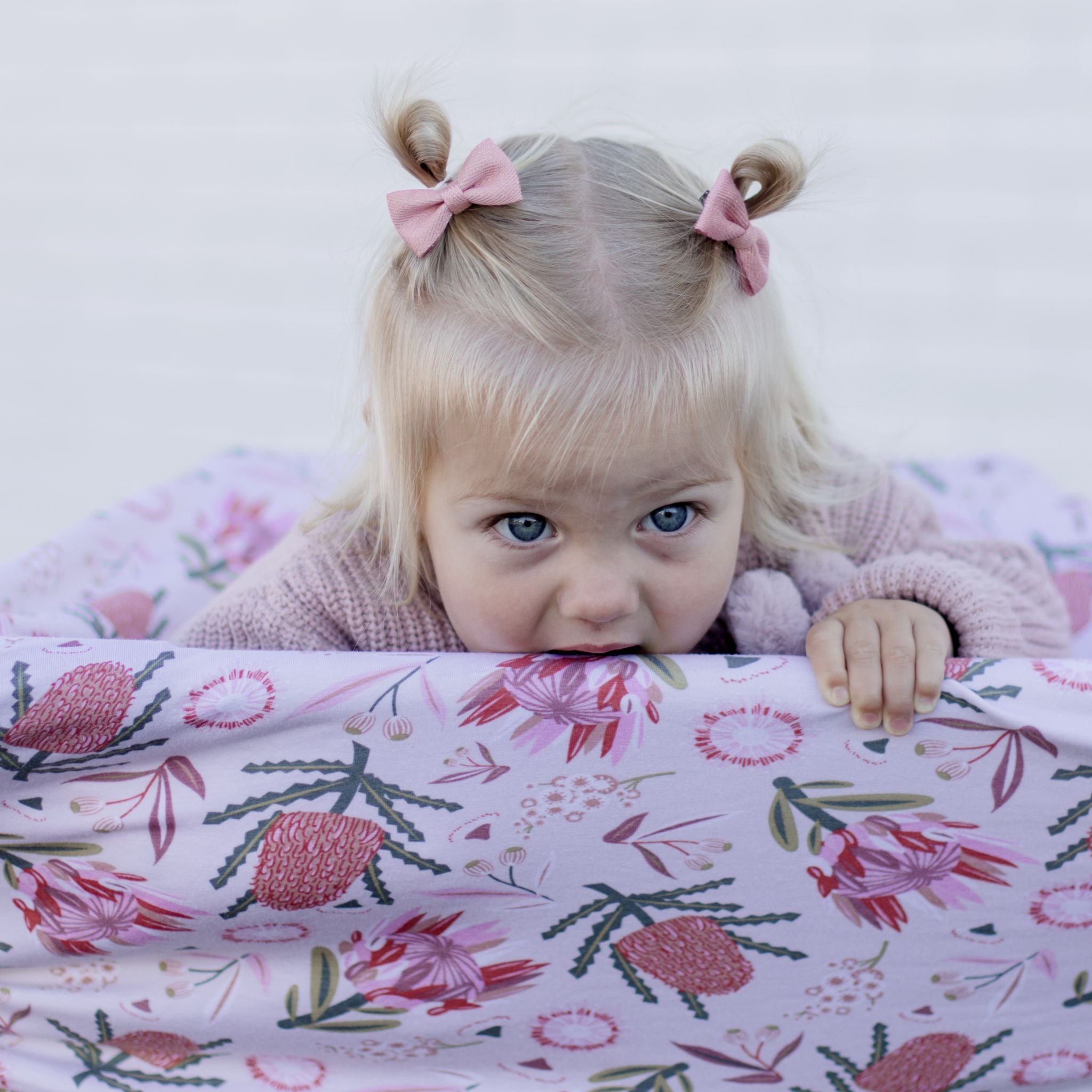 Gumnut Blossoms nursing cover draped over shoulder showing natural cotton fabric detail