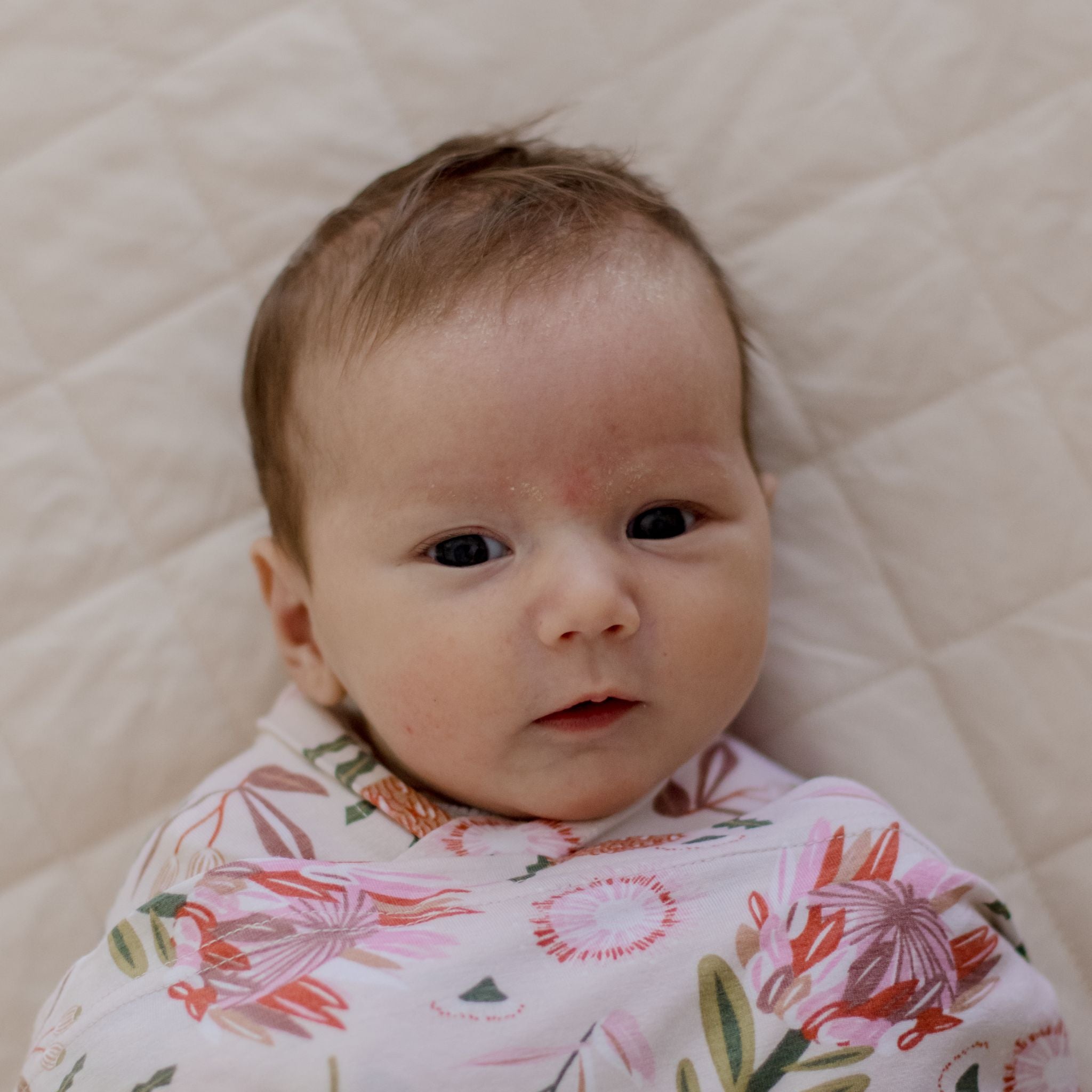 Stretchy swaddle wrap in gumnut blossom print detail packaging shot