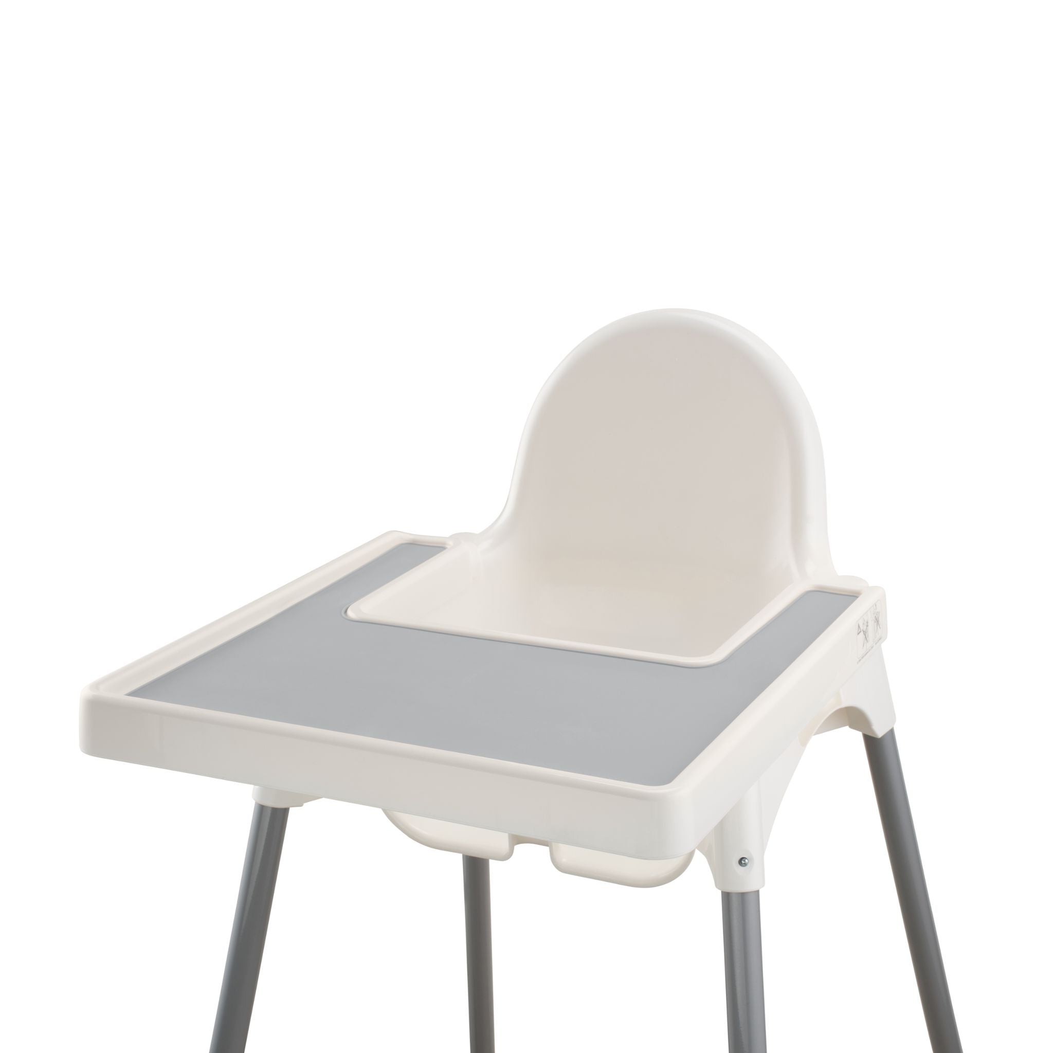Grey silicone placemat attached to white IKEA highchair during mealtime.