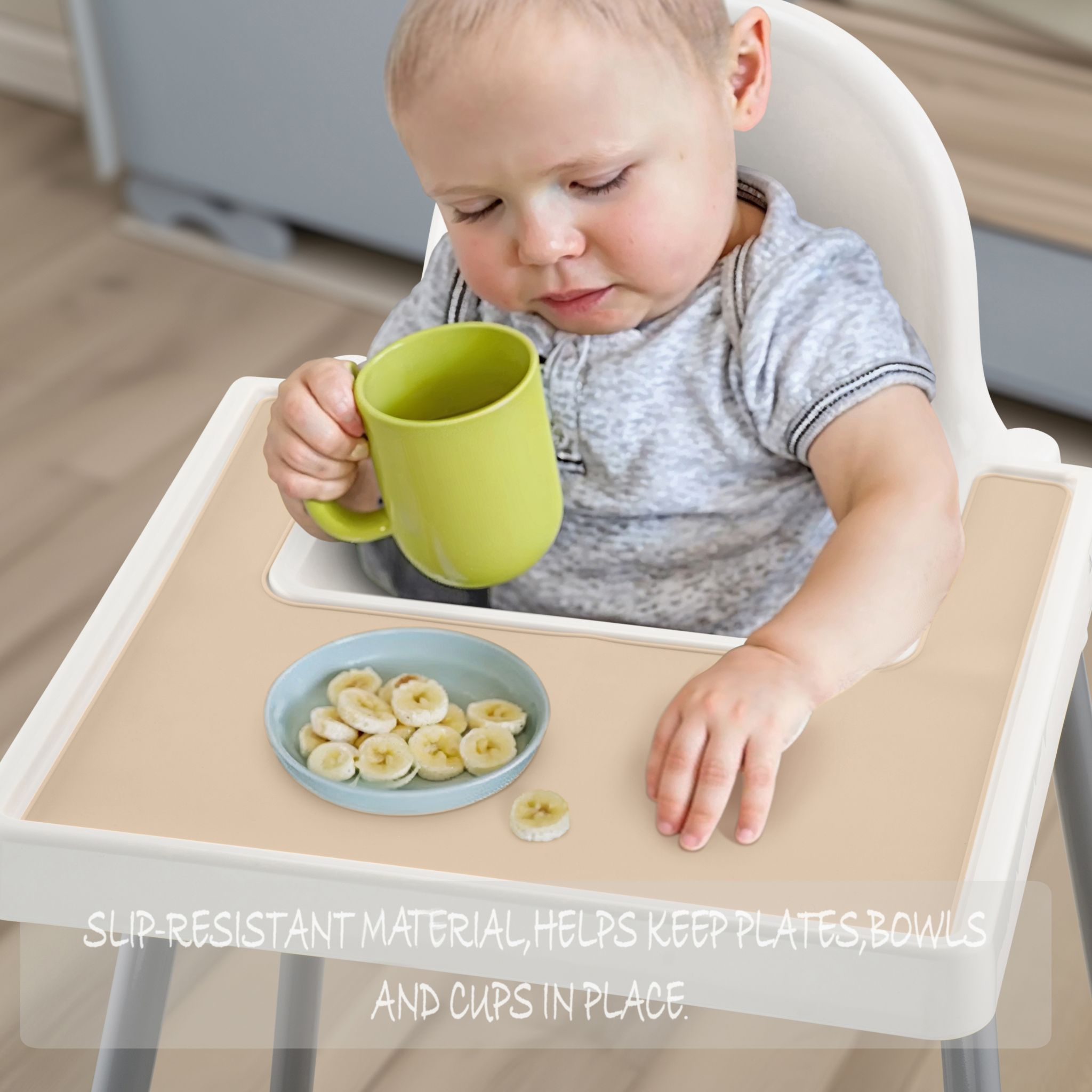 Beige silicone placemat attached to IKEA highchair for baby feeding