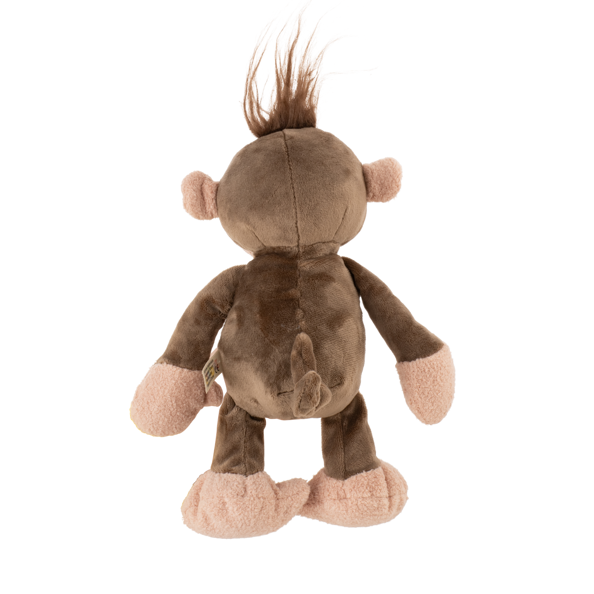 Soft plush brown monkey toy cuddled by a smiling child outdoors