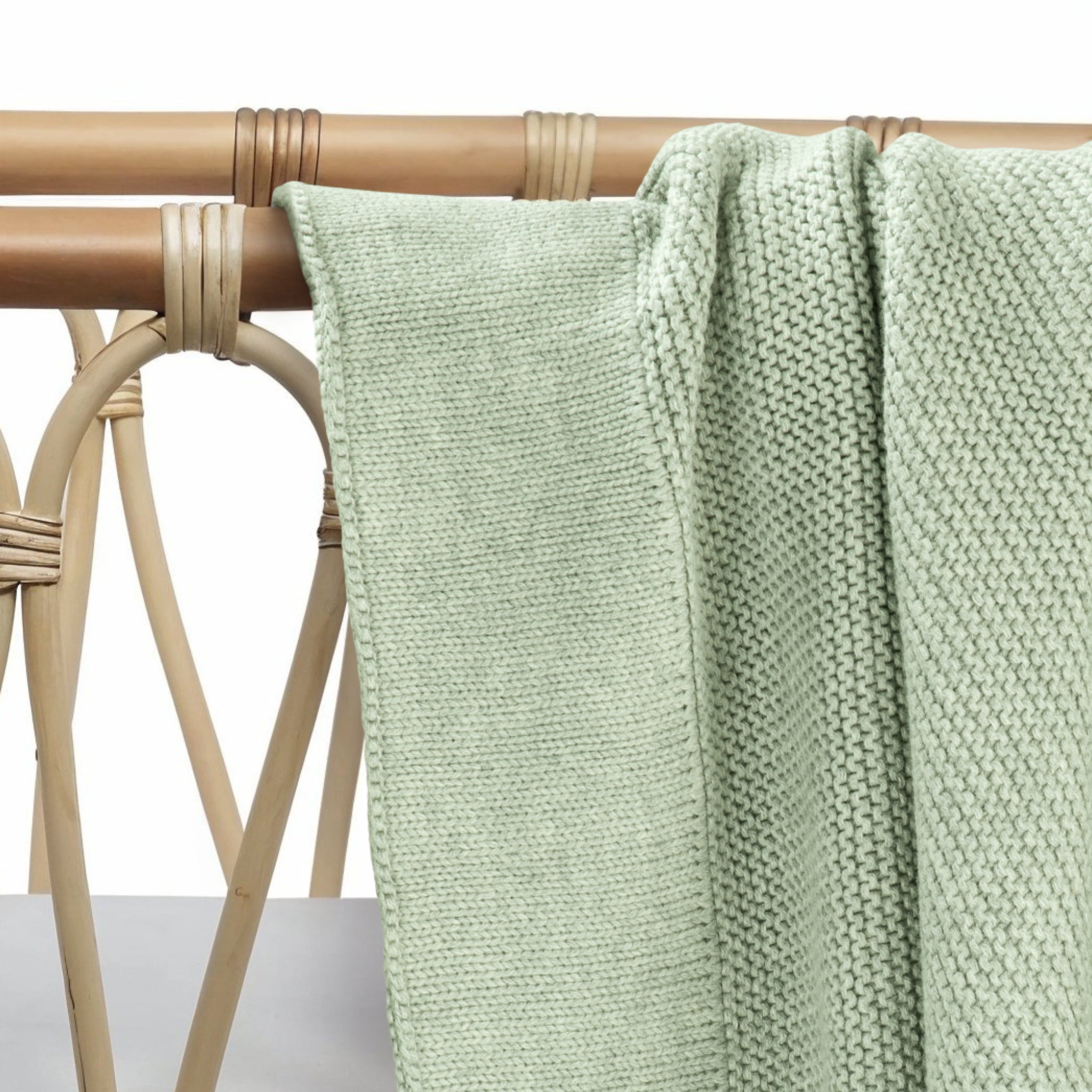 Soft cotton knit baby blanket in willow green folded neatly
