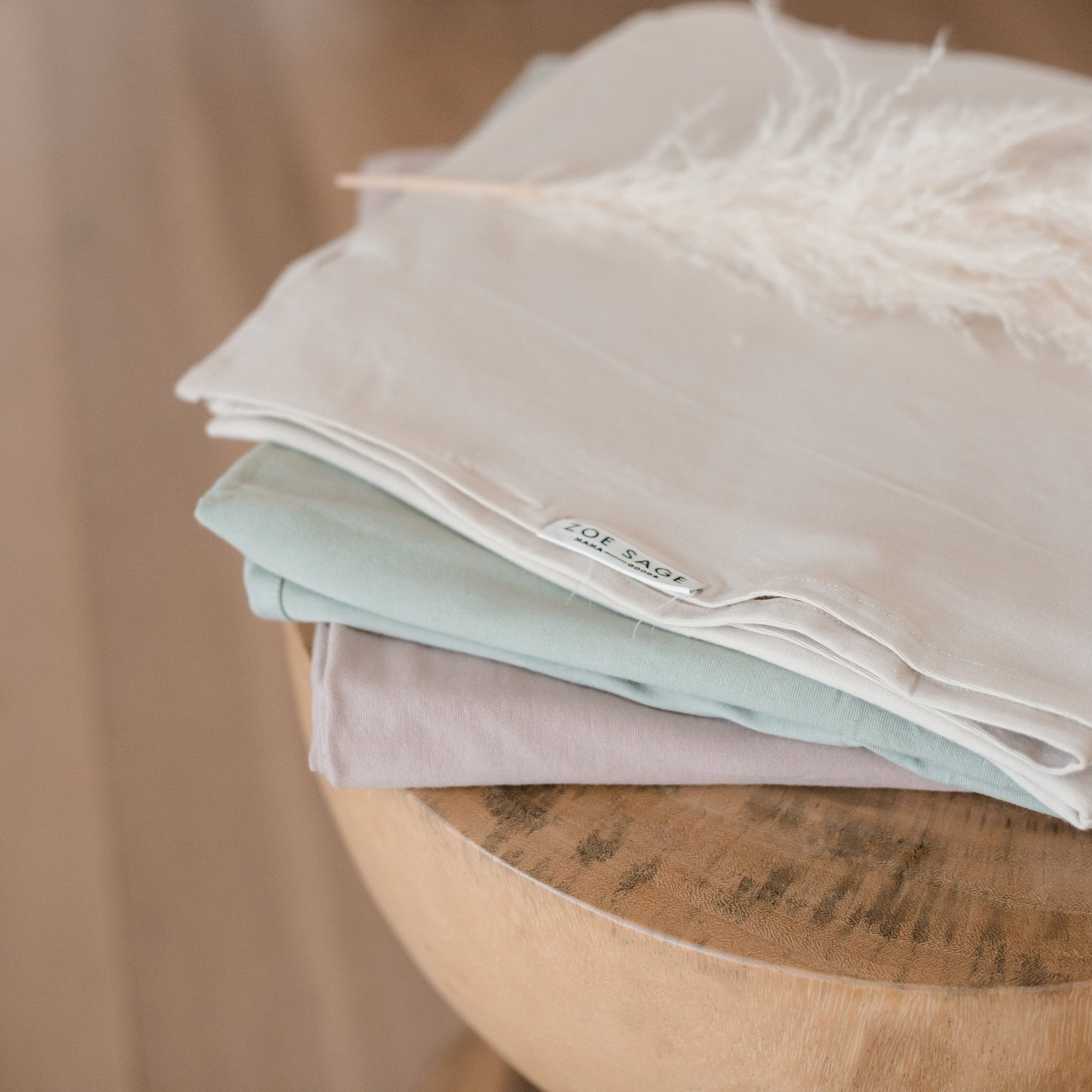 Oat stretchy baby swaddle wrap folded in packaging detail shot