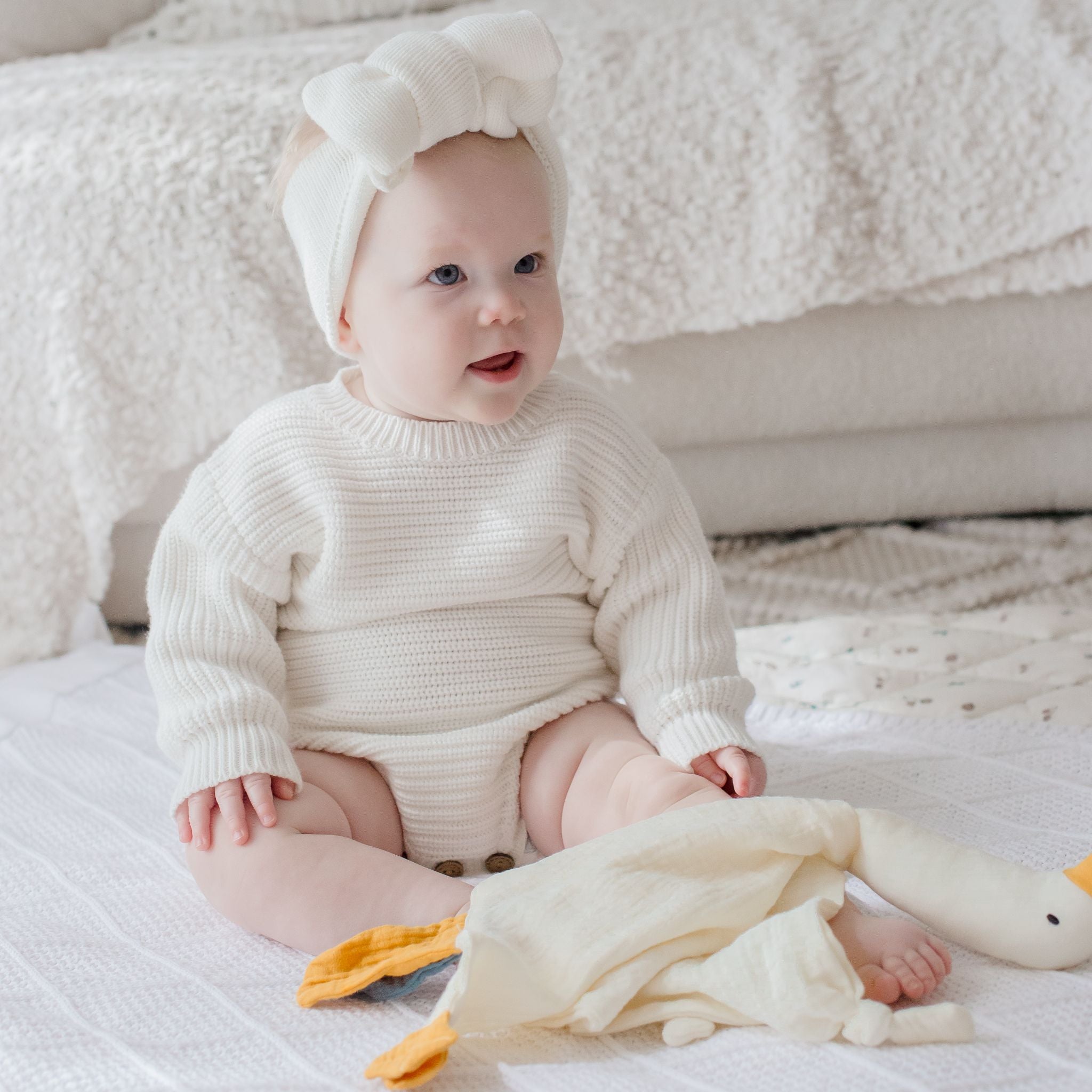 Parchment goose comforter security blanket draped softly on baby bedding