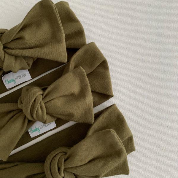 Close up detail of olive green baby bow knot headband fabric texture