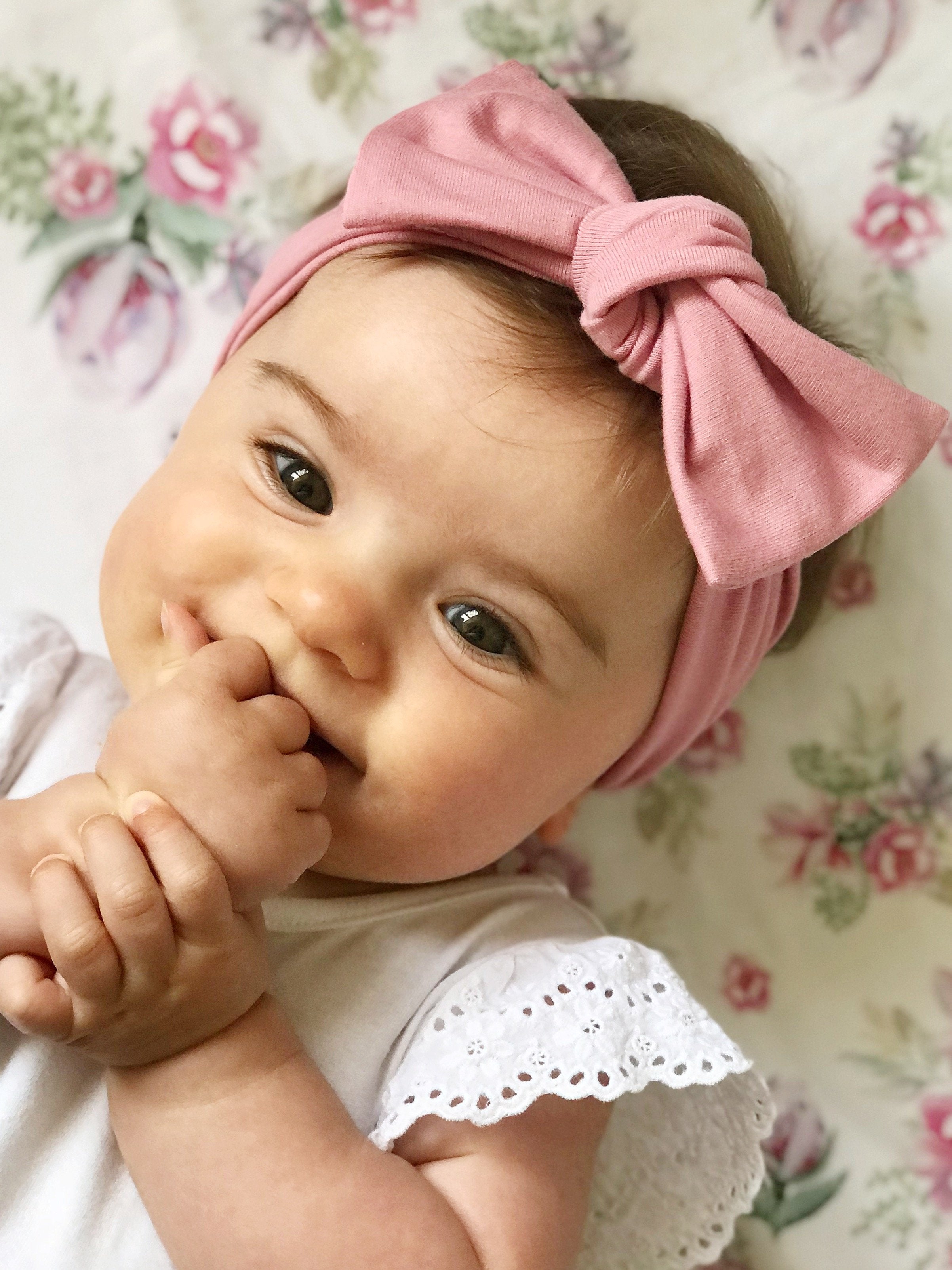 Rose pink baby bow knot headband displayed in eco friendly packaging
