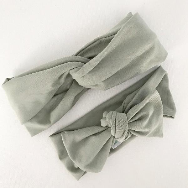 Sage green baby bow knot headband displayed on white background