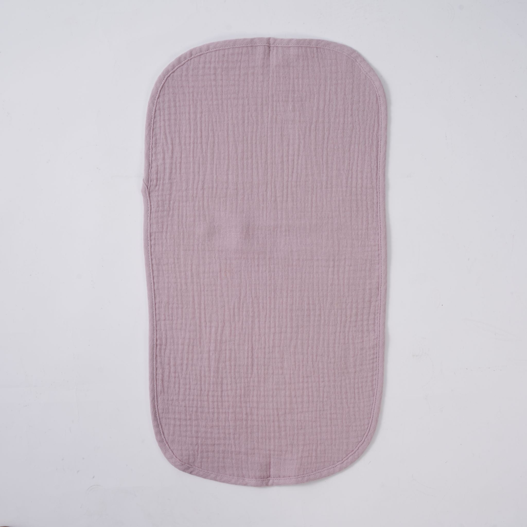Stack of five lavender blush organic muslin burp cloths folded neatly