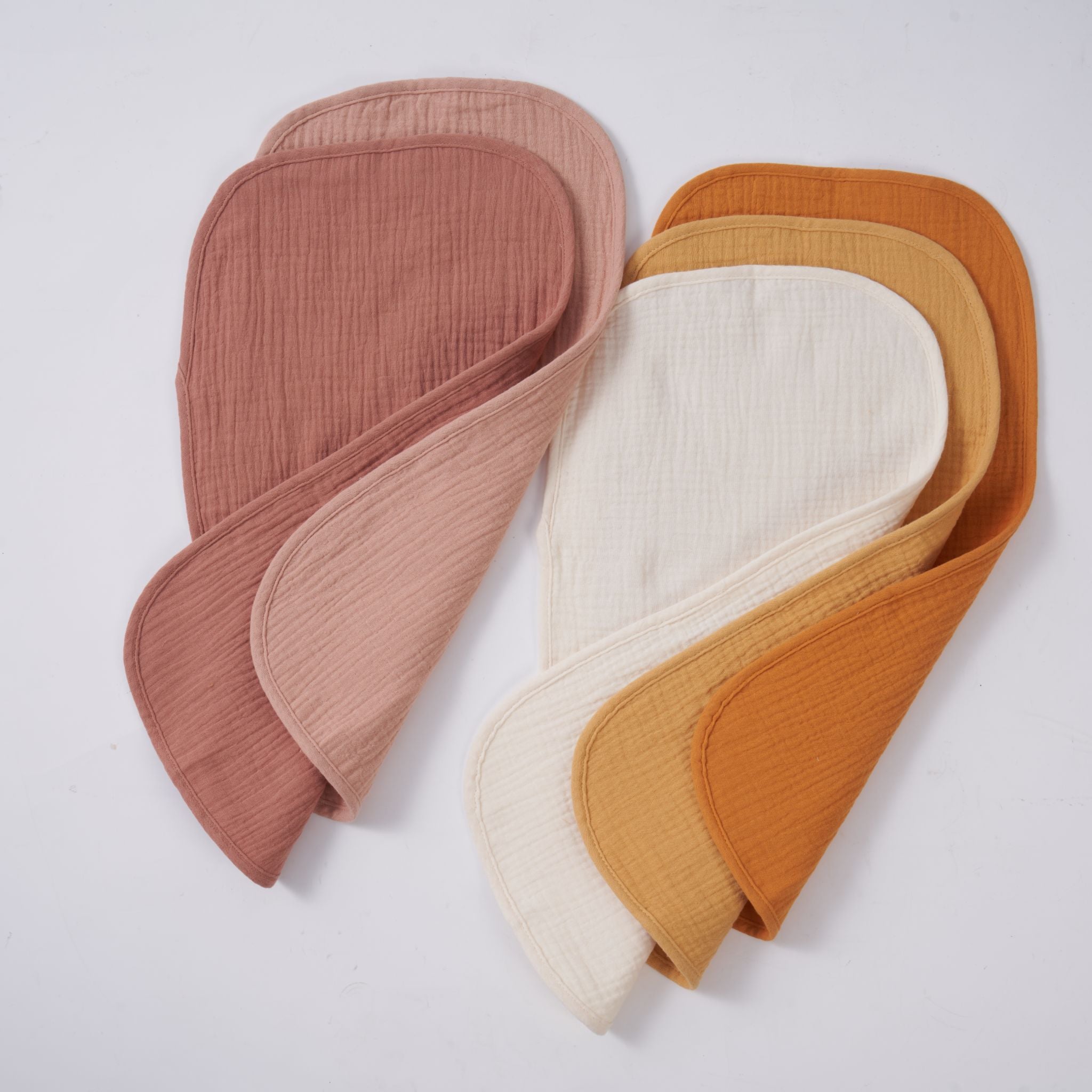 Folded organic muslin burp cloths in golden harvest colour, pack of five