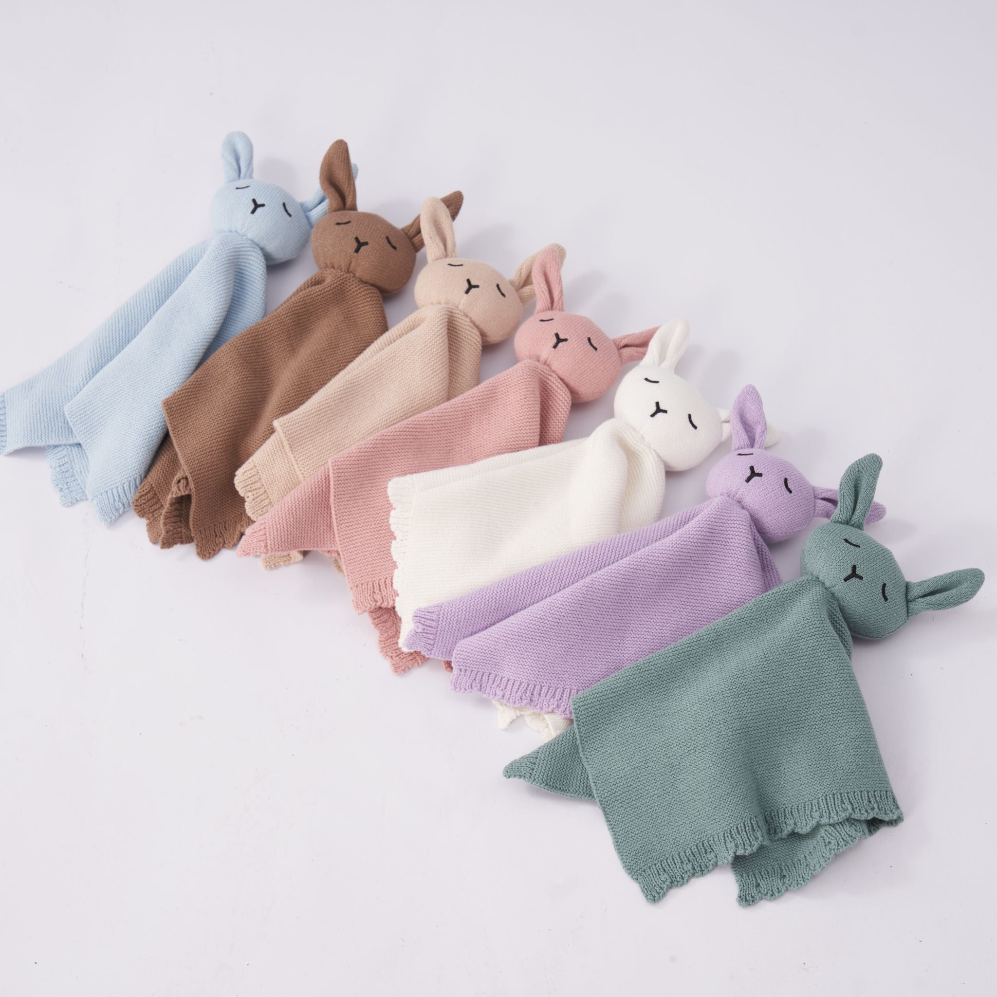 Mocha knitted lovey comforter laid flat showing soft texture and neutral tone