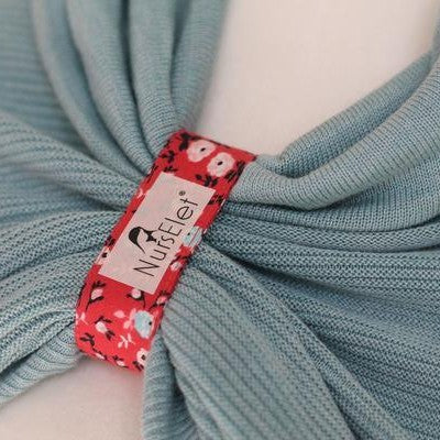 Blush pink nursing reminder bracelet worn on wrist during breastfeeding