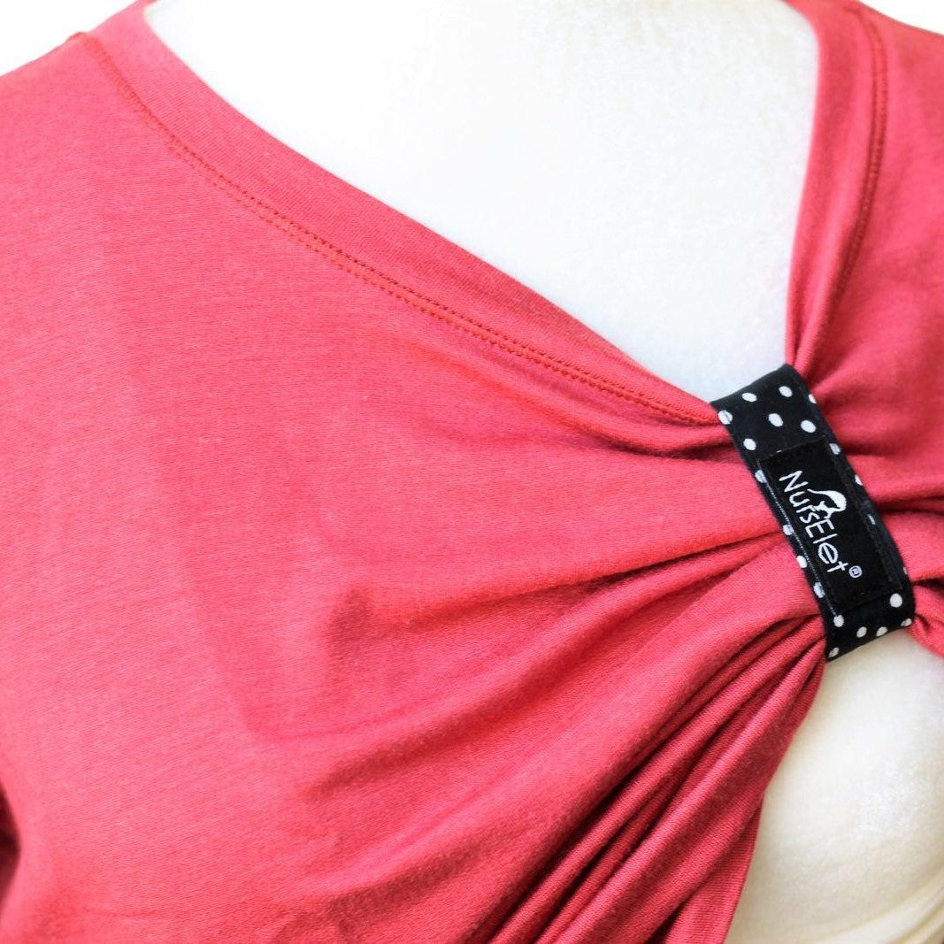 Monochrome dot nursing bracelet worn on wrist during breastfeeding