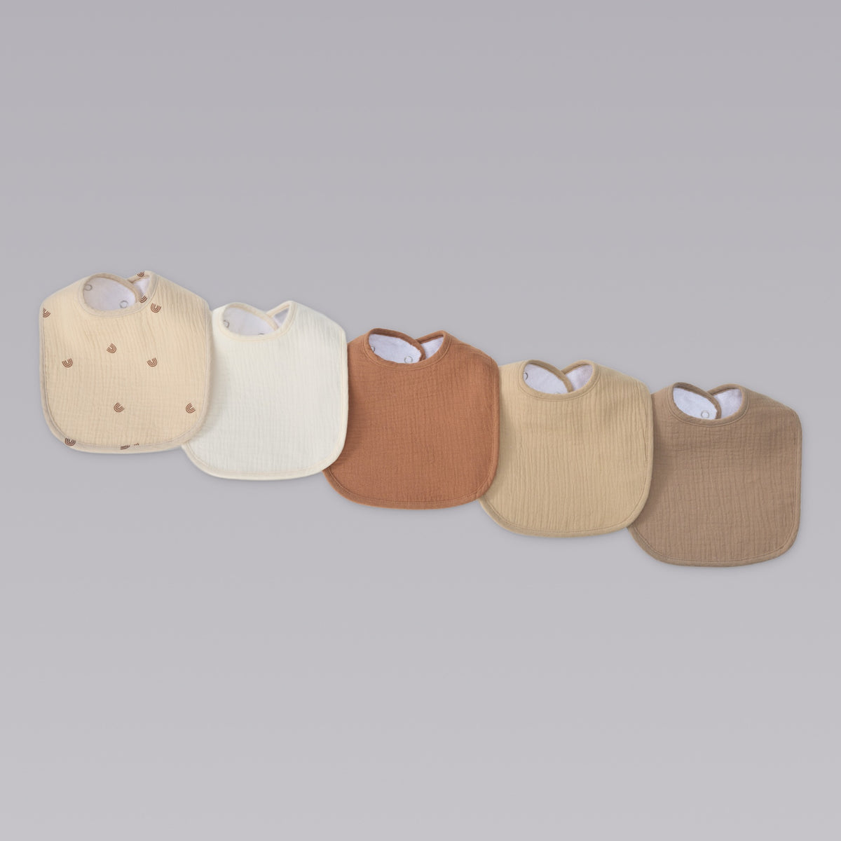 Organic muslin baby bibs in dusty dunes tones by Zoe Sage, five pack colour fan