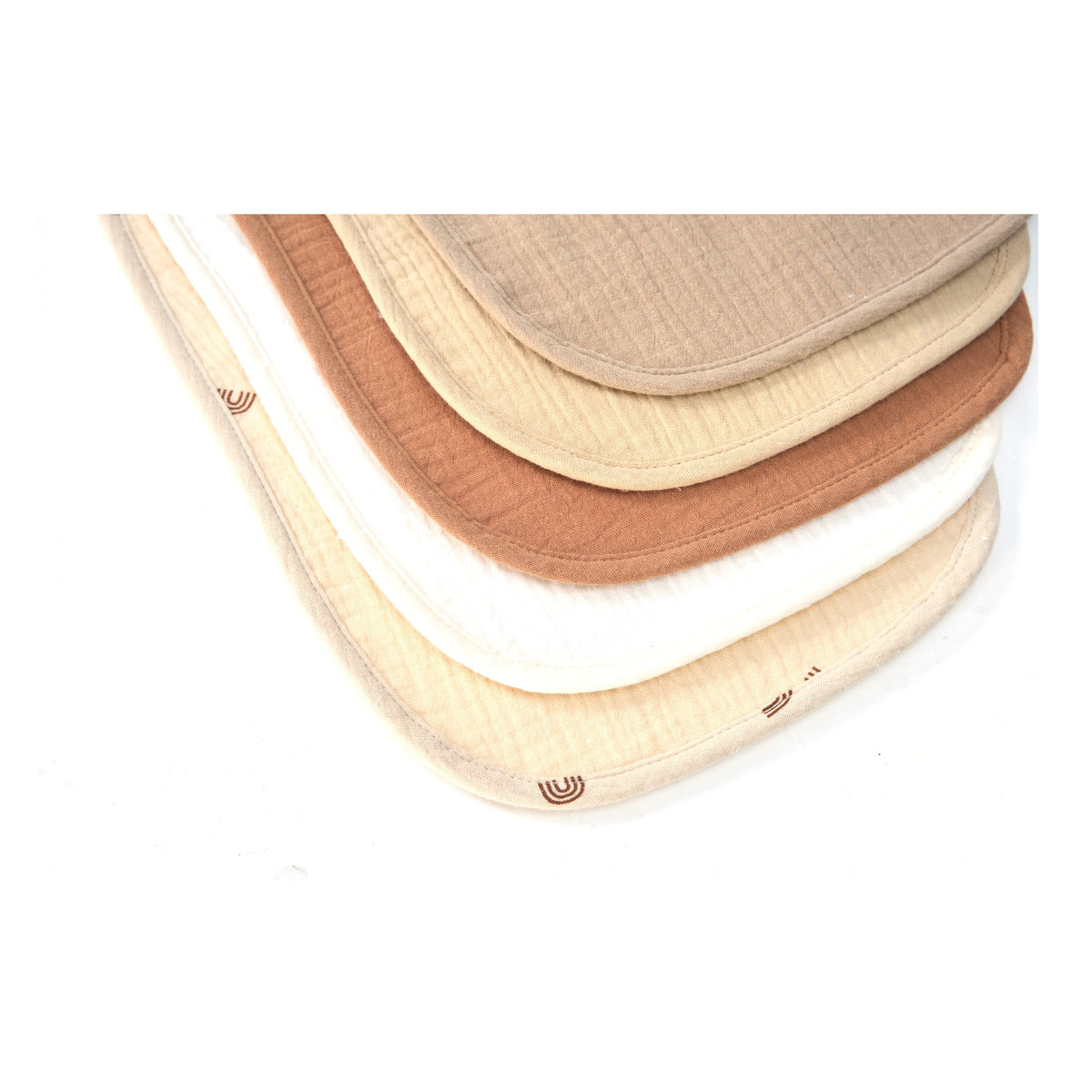 Stacked organic muslin baby bibs in Dusty Dunes colours, close up of the weave
