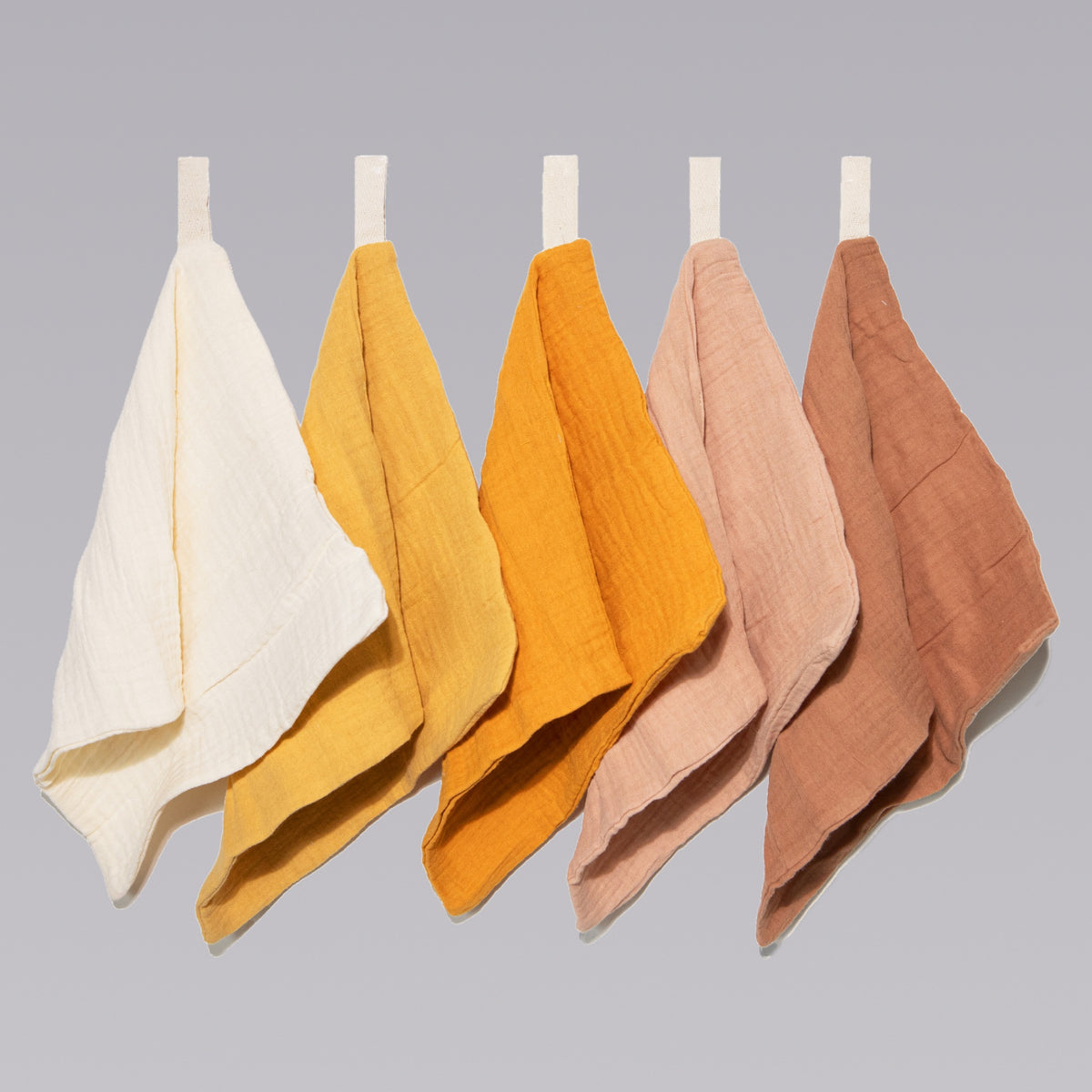 Five soft organic muslin wash cloths in golden harvest tone by Zoe Sage