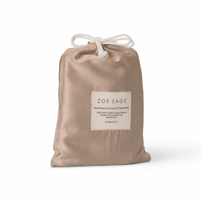 Mocha waterproof bassinet sheet and change pad cover in its drawstring storage bag, Zoe Sage
