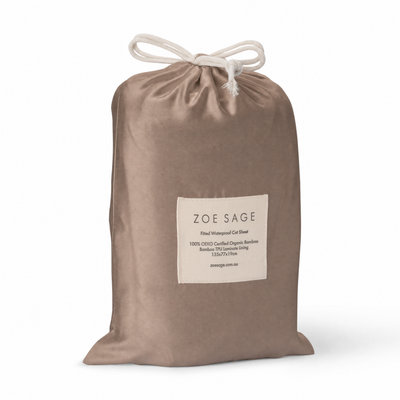 Mocha waterproof fitted cot sheet in its drawstring storage bag, Zoe Sage