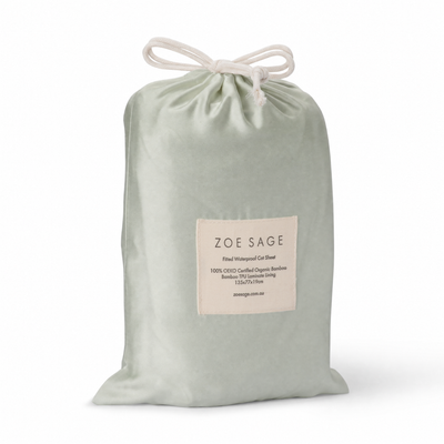Sage waterproof fitted cot sheet in its drawstring storage bag, Zoe Sage