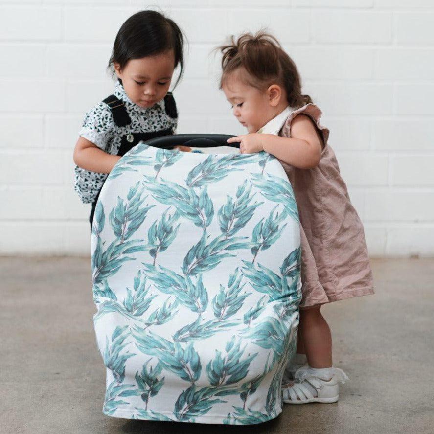 Blue gum leaf nursing cover draped over shoulder for breastfeeding